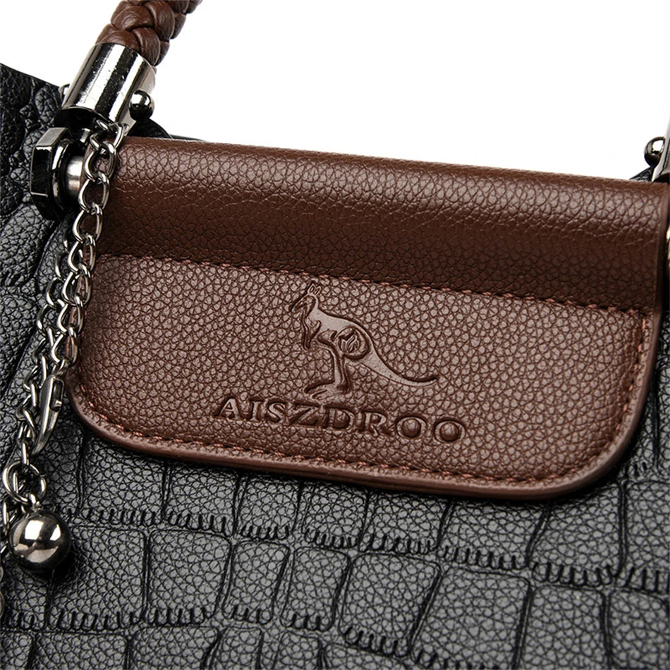 A stylish genuine leather alligator shoulder bag adorned with letter, sequined, kangaroo, and leaf ornament decorations, perfect for women on the go.