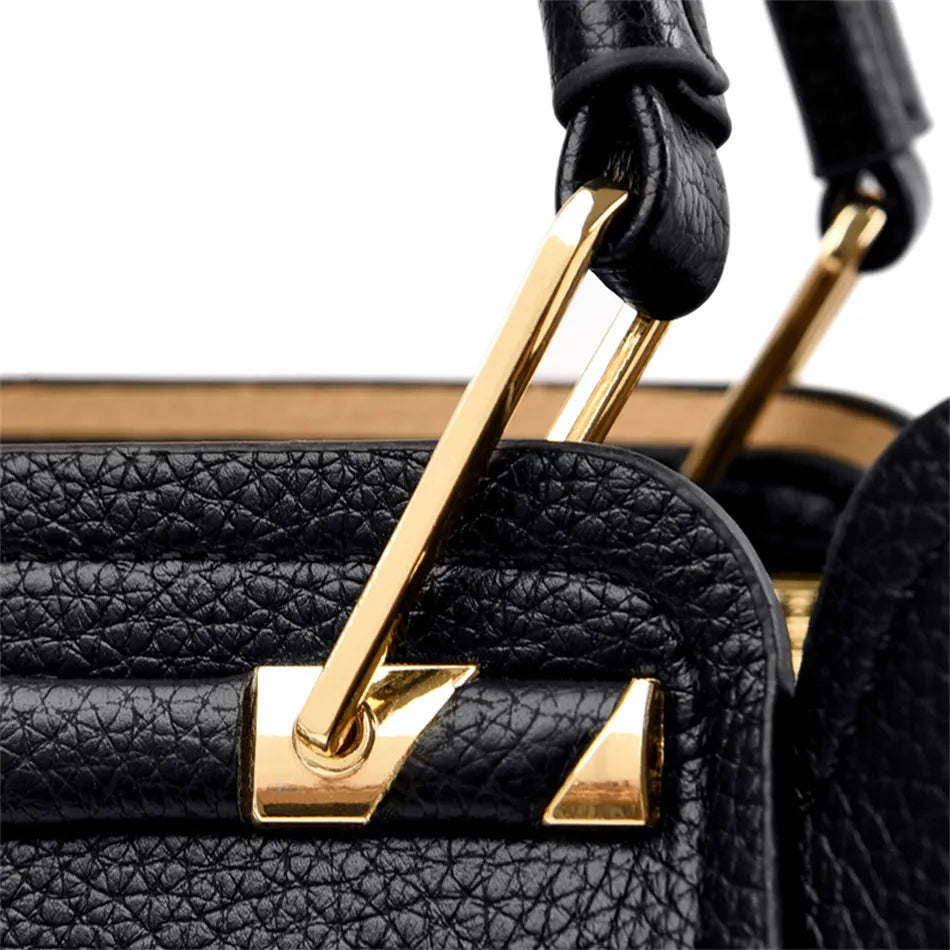 A stylish soft leather triple layer crossbody tote handbag with letter and kangaroo pendant decorations, perfect for women on the go.