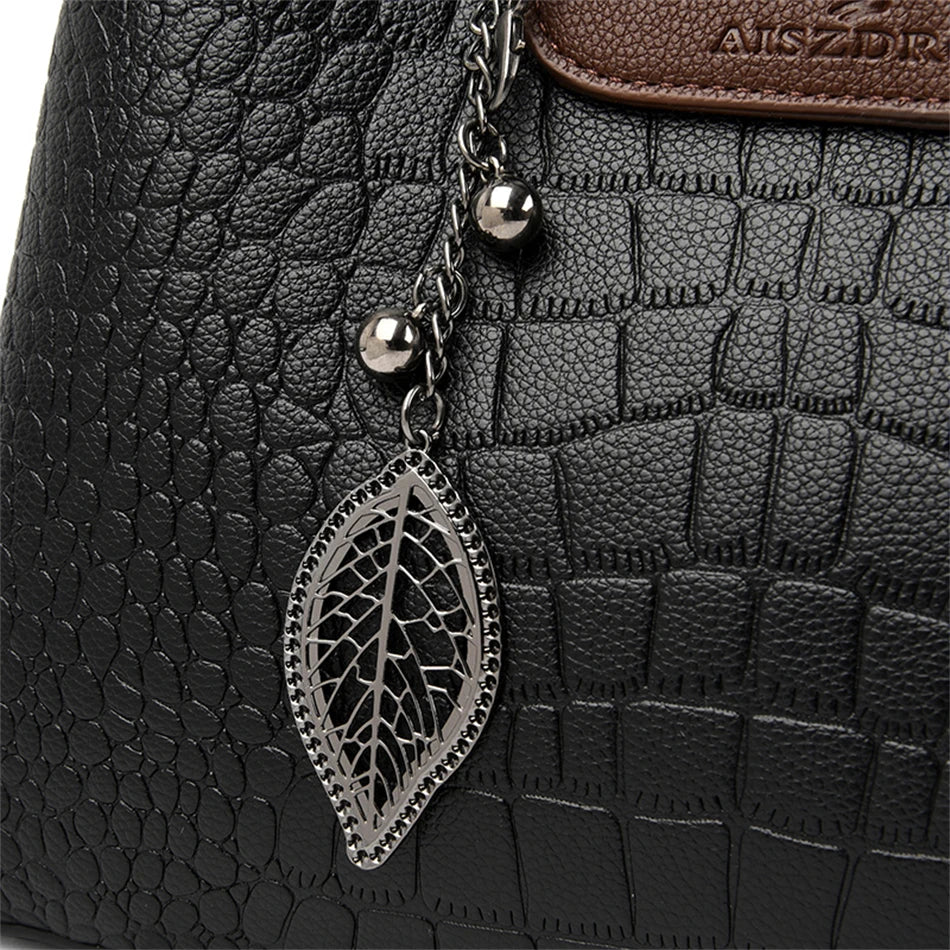 A stylish genuine leather alligator shoulder bag adorned with letter, sequined, kangaroo, and leaf ornament decorations, perfect for women on the go.