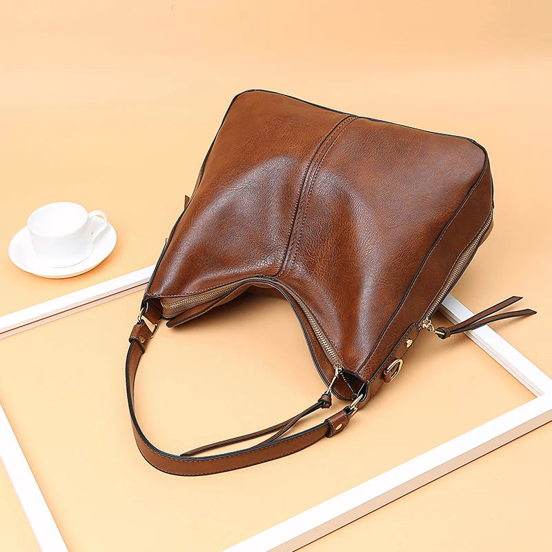 A stylish PU leather shoulder hobo bag with zipper closure and multiple interior pockets, perfect for versatile use by women.