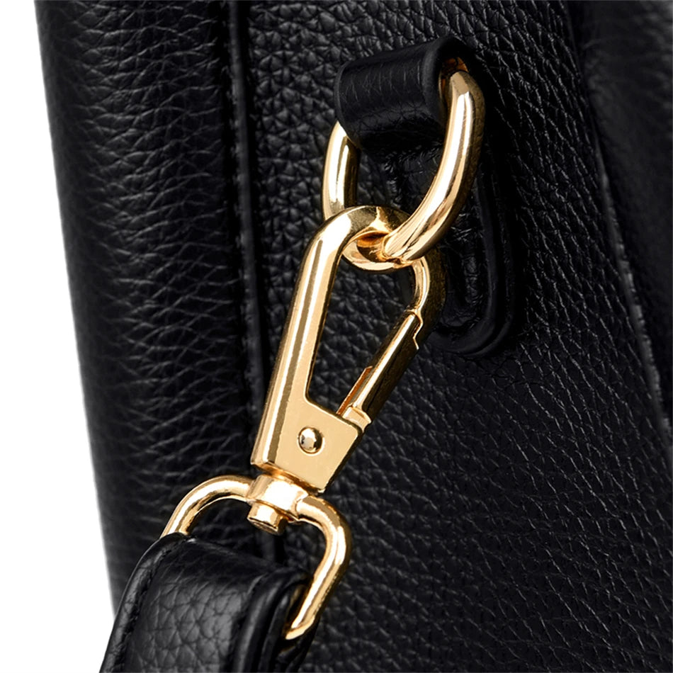 A stylish soft leather triple layer crossbody tote handbag with letter and kangaroo pendant decorations, perfect for women on the go.