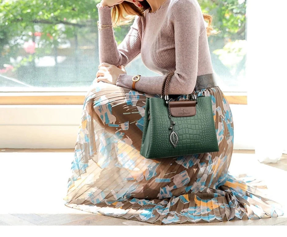 A stylish genuine leather alligator shoulder bag adorned with letter, sequined, kangaroo, and leaf ornament decorations, perfect for women on the go.