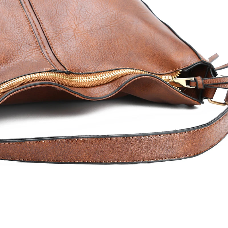 A stylish PU leather shoulder hobo bag with zipper closure and multiple interior pockets, perfect for versatile use by women.