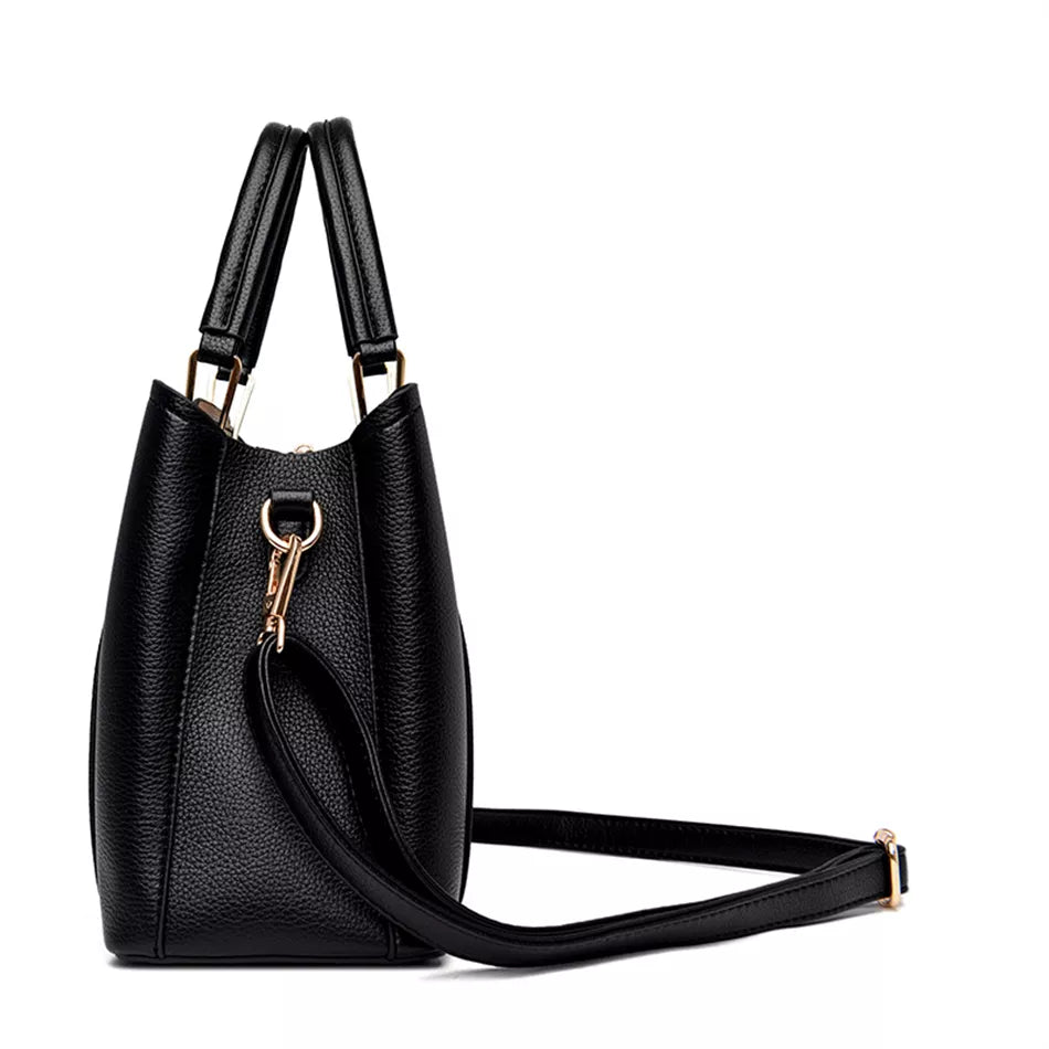 A stylish soft leather triple layer crossbody tote handbag with letter and kangaroo pendant decorations, perfect for women on the go.