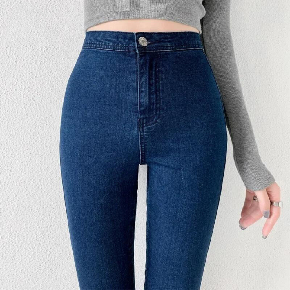 A pair of Cotton Elastic Denim Jeans in light blue, featuring a mid-waist fit, button fly closure, and sash and button decorations. These full-length pencil pants offer high stretch fabric for comfort and style, perfect for all occasions.