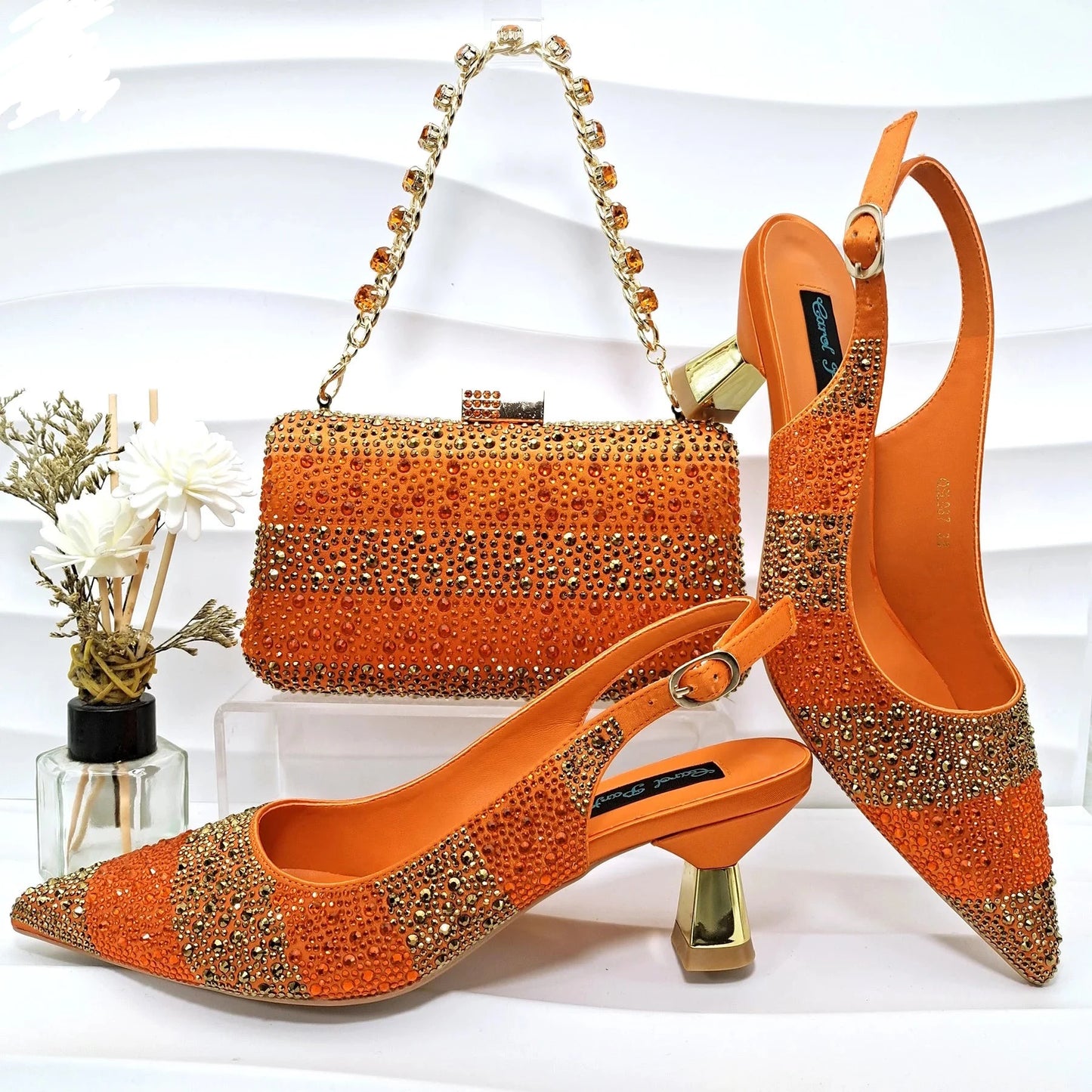 Image of Fashion Forward Strange Style Slingback Pumps in orange color, featuring a pointed toe, super high strange style heel, and crystal embellishments. Perfect for parties and special occasions.