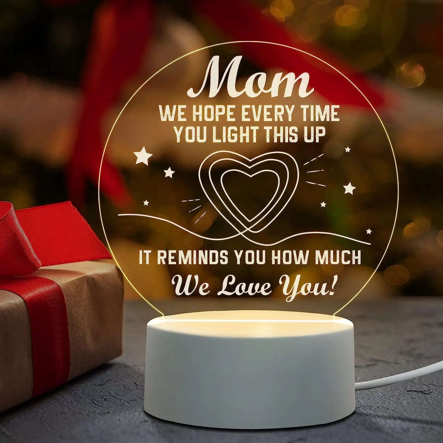 A close-up of an Engraved Acrylic Mom Night Light with LED bulbs, featuring a DIY shape and engraved with heartfelt sentiments. The night light is illuminated with a warm glow, perfect for bedroom decor.