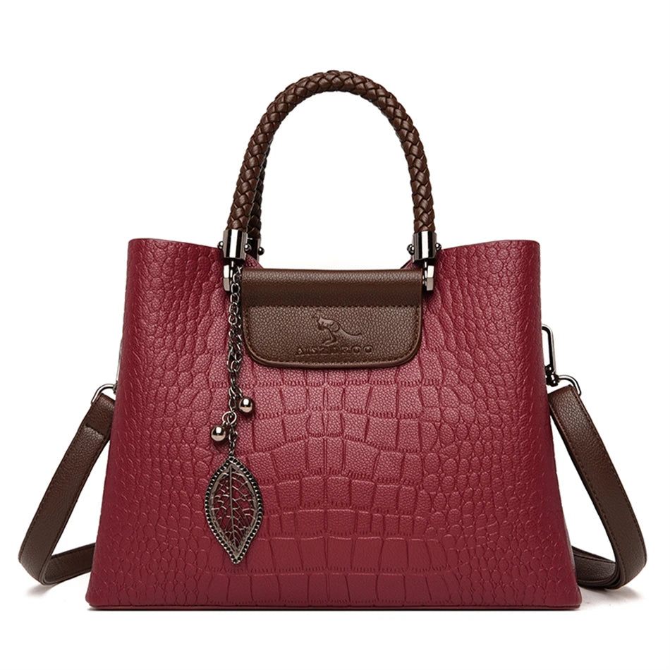 A stylish genuine leather alligator shoulder bag adorned with letter, sequined, kangaroo, and leaf ornament decorations, perfect for women on the go.
