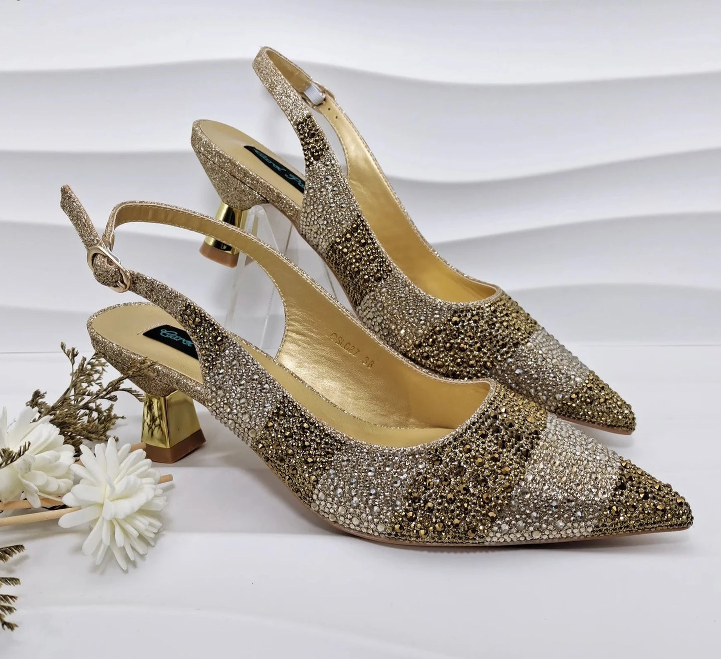 Image of Fashion Forward Strange Style Slingback Pumps in gold color, featuring a pointed toe, super high strange style heel, and crystal embellishments. Perfect for parties and special occasions.