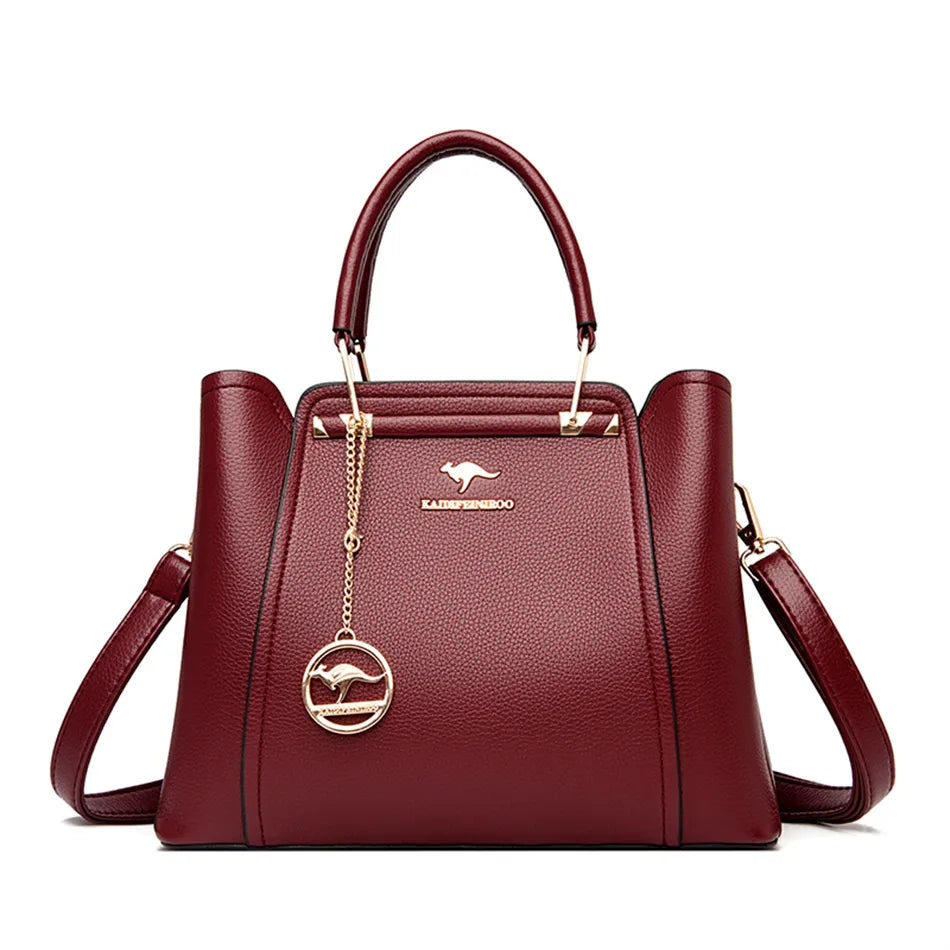 A stylish soft leather triple layer crossbody tote handbag with letter and kangaroo pendant decorations, perfect for women on the go.