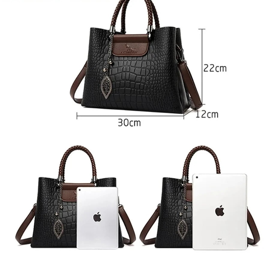 A stylish genuine leather alligator shoulder bag adorned with letter, sequined, kangaroo, and leaf ornament decorations, perfect for women on the go.