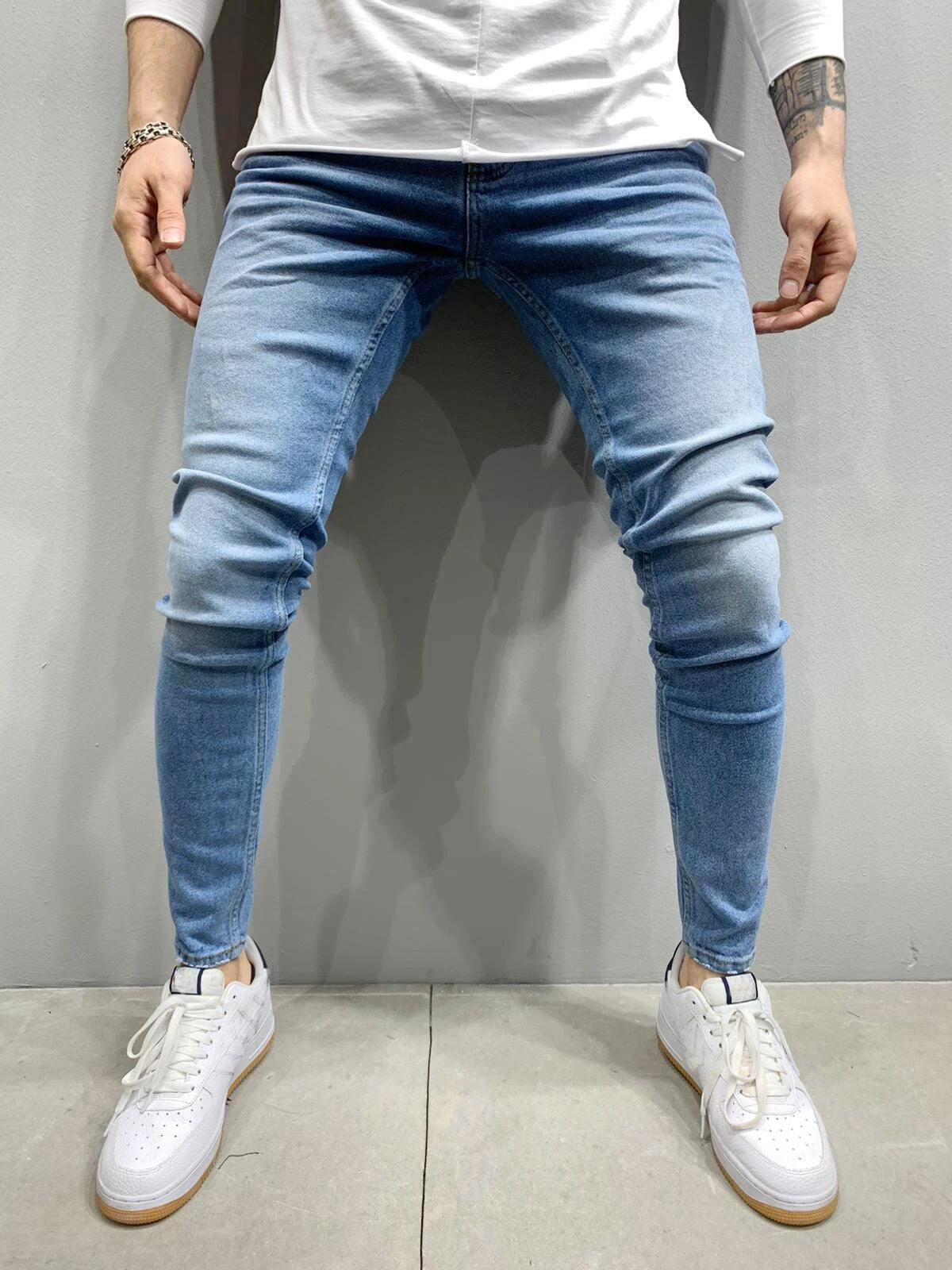 Men's Fashion Street Style Ripped Skinny Jeans with stonewashed and distressed details. Perfect for spring and autumn street style.