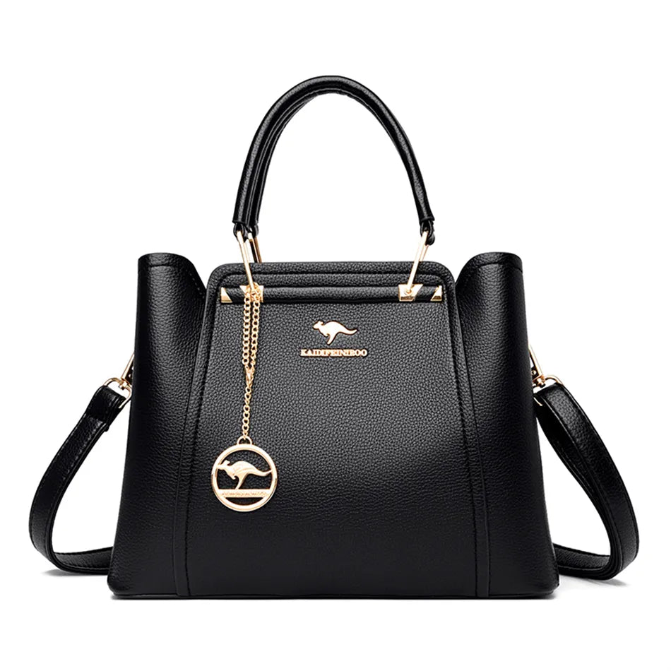 A stylish soft leather triple layer crossbody tote handbag with letter and kangaroo pendant decorations, perfect for women on the go.