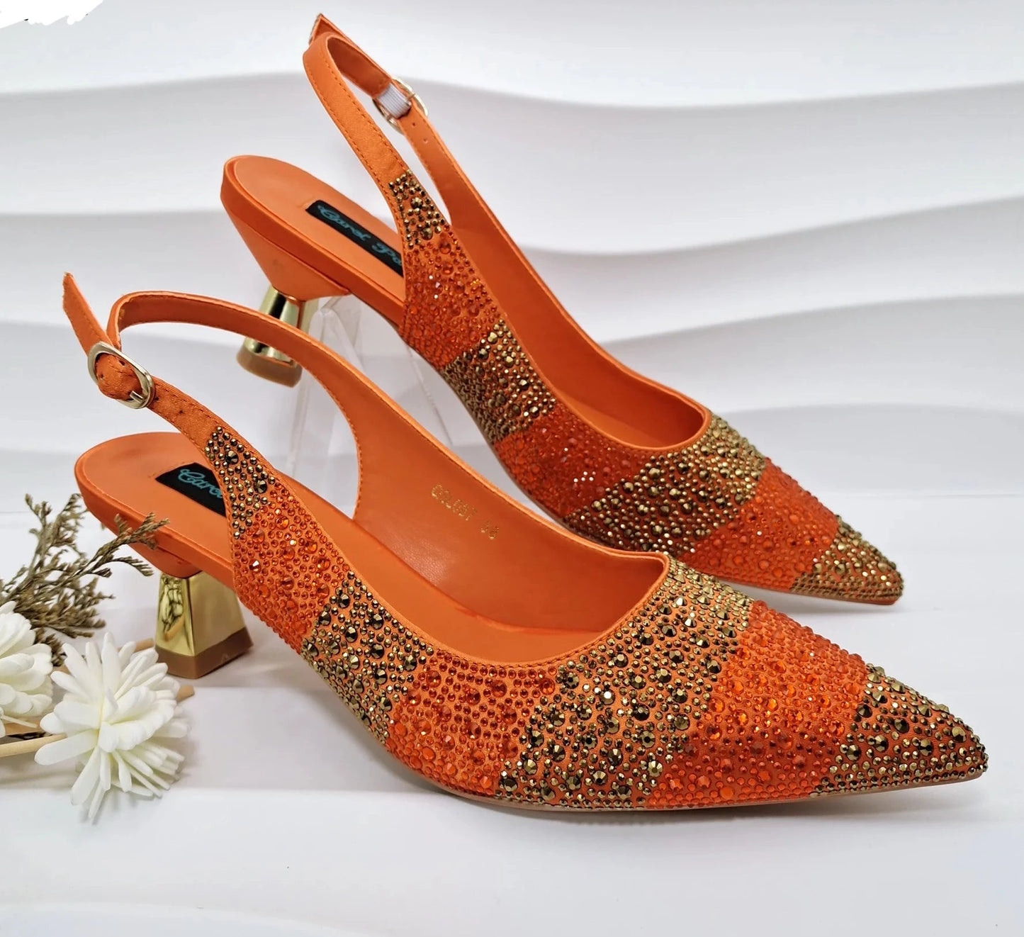 Image of Fashion Forward Strange Style Slingback Pumps in orange color, featuring a pointed toe, super high strange style heel, and crystal embellishments. Perfect for parties and special occasions.