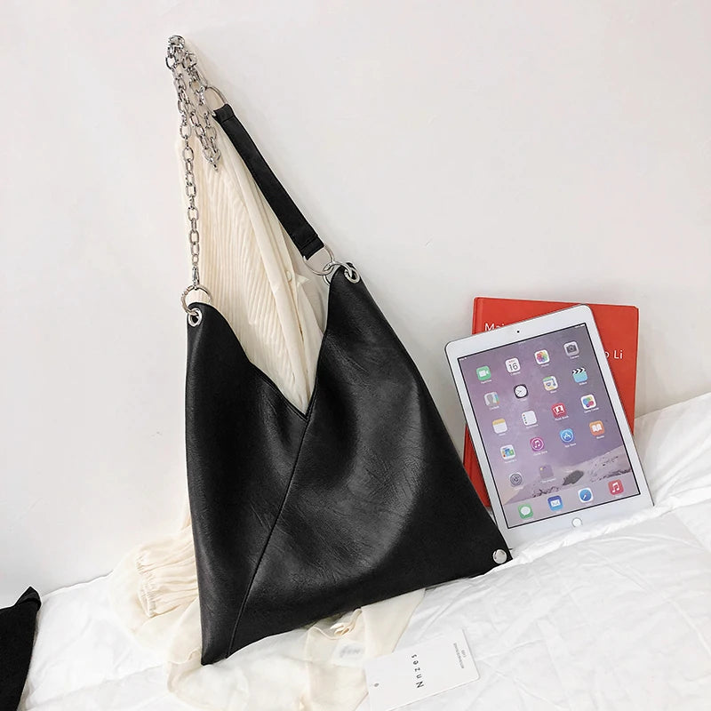 A stylish PU leather simple shoulder bag with rivet decoration, perfect for versatile use by women.
