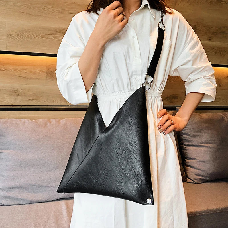 A stylish PU leather simple shoulder bag with rivet decoration, perfect for versatile use by women.