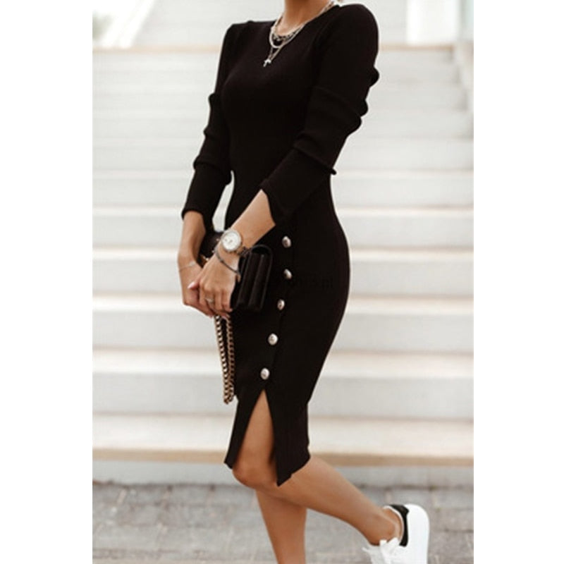 A woman wearing a Mini Skinny Winter Dress in black, featuring a v-neck design and button details, perfect for staying warm and stylish on a winter evening out