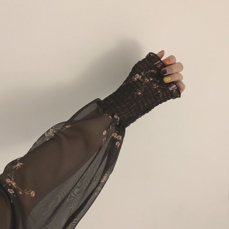 Chic black vintage spring dress with unique puff sleeves, ruffles, and A-line silhouette, made from comfortable and durable synthetic fiber, acrylic, and chiffon fabric.