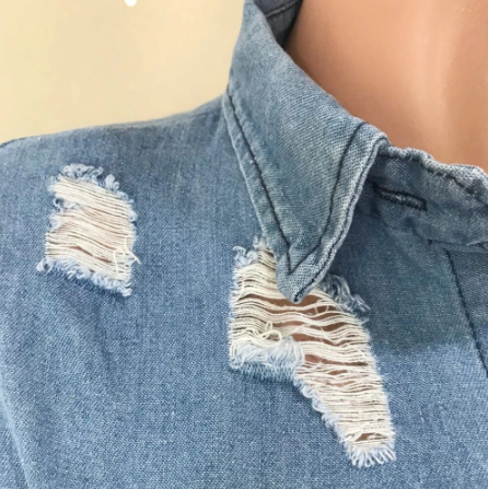 Chic woman wearing Long Denim Jacket with turn-down collar and empire waistline, styled as a mini dress with high heels