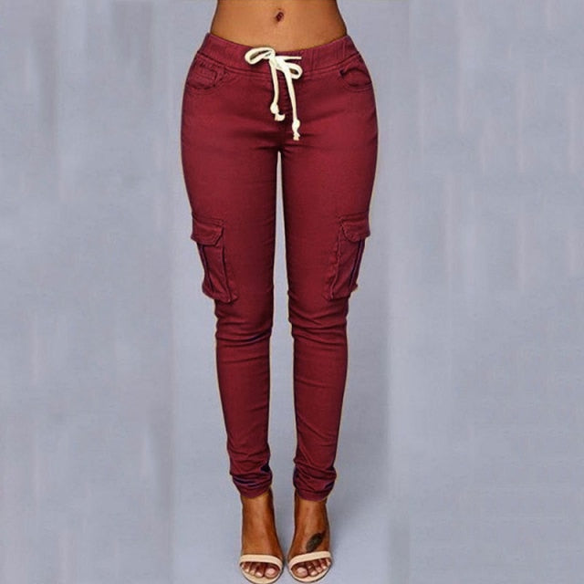 A woman wearing High Waist Jogger Pants in black color with pockets, elastic waistband and drawstring closure