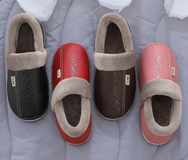 A pair of men's indoor slippers made of proportioned PU and plush insole material. The slippers are a light brown color and have a comfortable, relaxed design.