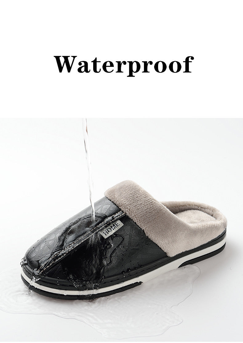 A pair of men's indoor slippers made of proportioned PU and plush insole material. The slippers are a light brown color and have a comfortable, relaxed design.