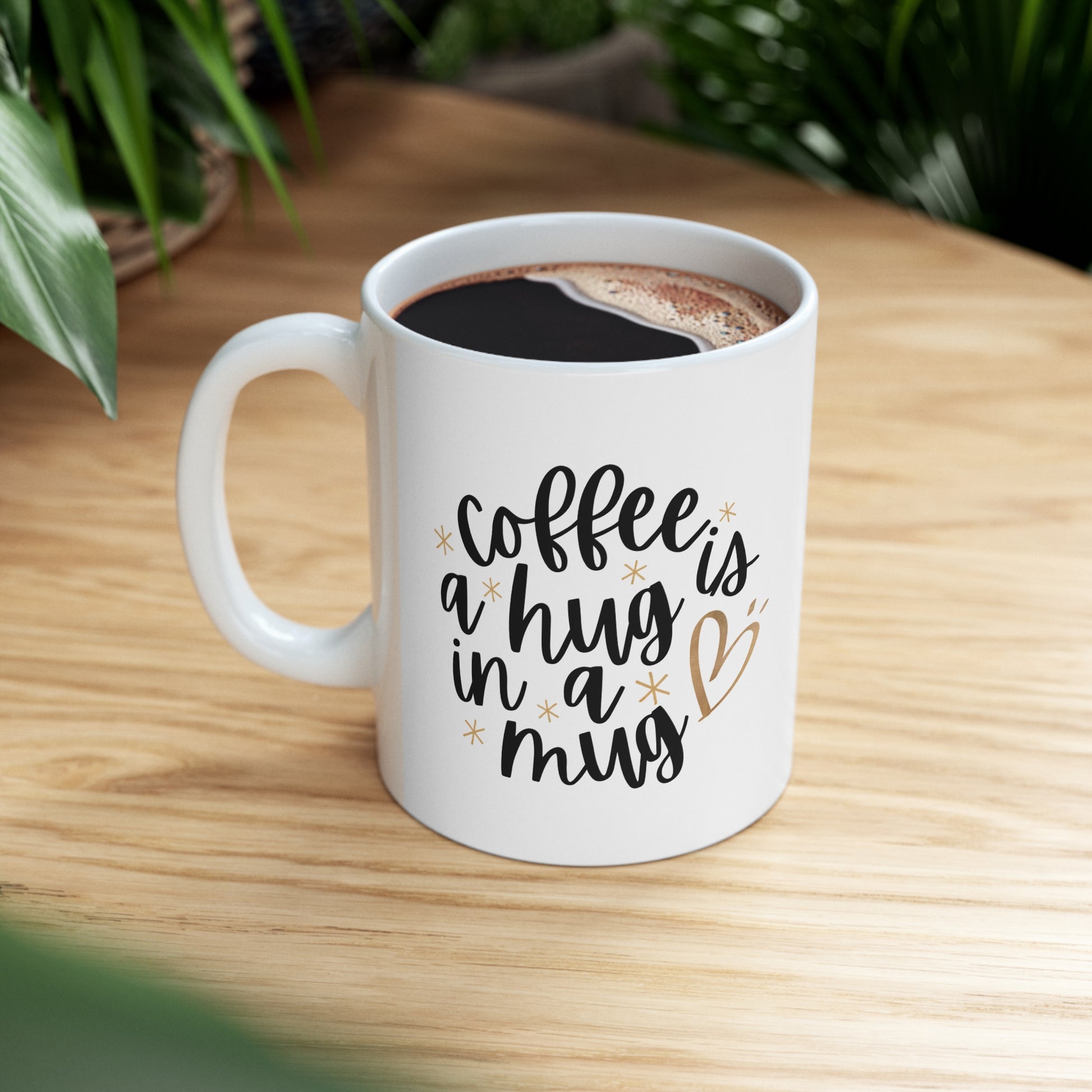 Custom-designed ceramic mug with "Coffee is a Hug in a Mug" design, 11 oz capacity.