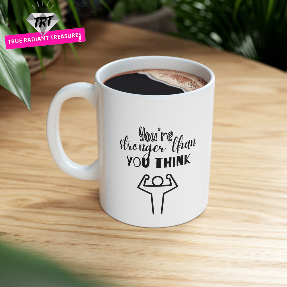 Custom-designed ceramic mug with "You're Stronger than You Think" design, 11 oz capacity.