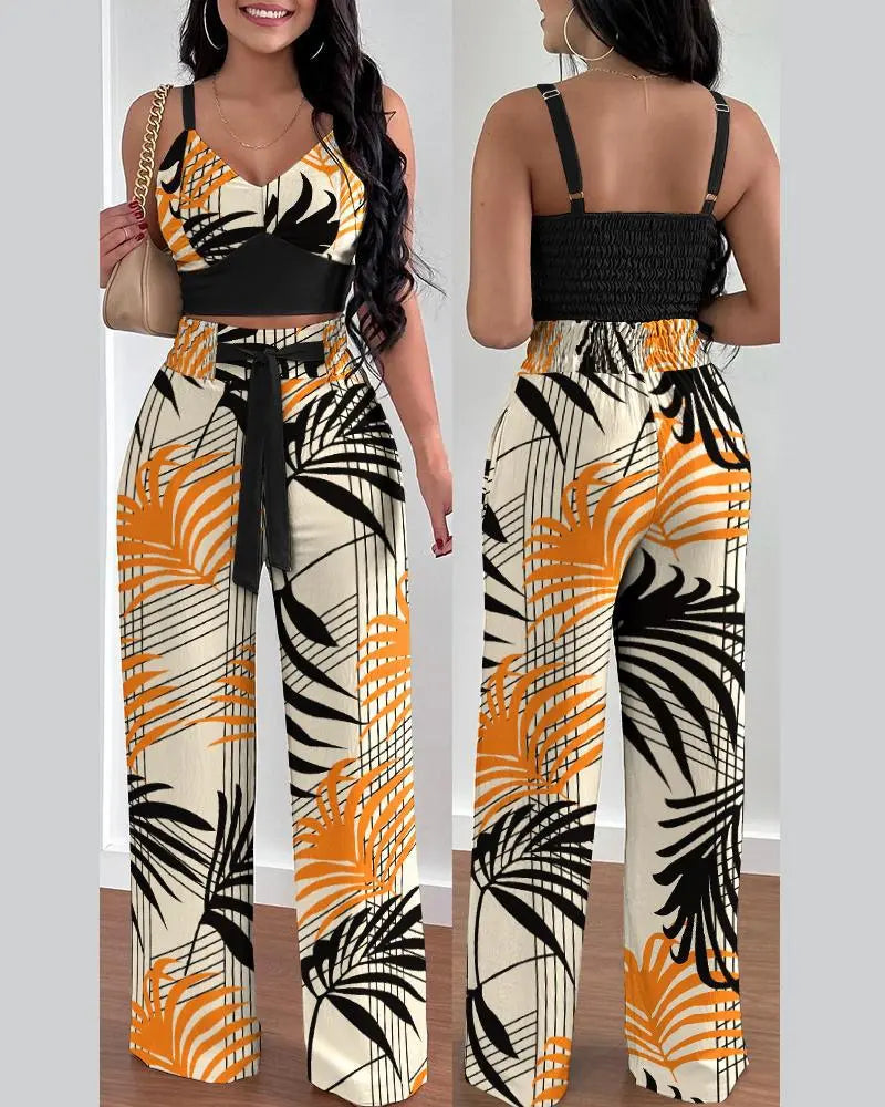 Summer Printed Two-Piece Set with V-neck sleeveless crop top and high-waist wide-leg pants. Made from blended POLYESTER fabric with lace-up decoration. Chic and comfortable summer fashion for women aged 18-24.