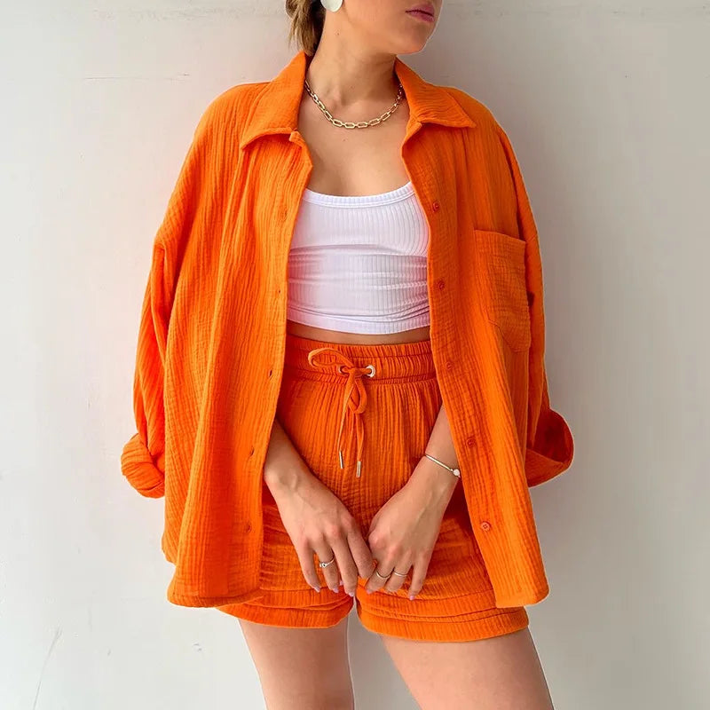 Two-Piece Buttoned Short Set for Women - Casual polo-neck top and knee-length pants set made from high-quality cotton fabric. Perfect for spring/summer 2024.