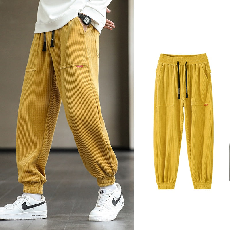 Men's Autumn Corduroy Sweatpants - Comfortable midweight design with drawstring closure. Available in sizes M to 8XL, in colors like Black, Blue, Grey, White, Yellow, and Brown. Perfect for autumn and winter.