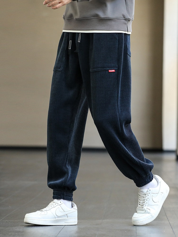 Men's Autumn Corduroy Sweatpants - Comfortable midweight design with drawstring closure. Available in sizes M to 8XL, in colors like Black, Blue, Grey, White, Yellow, and Brown. Perfect for autumn and winter.