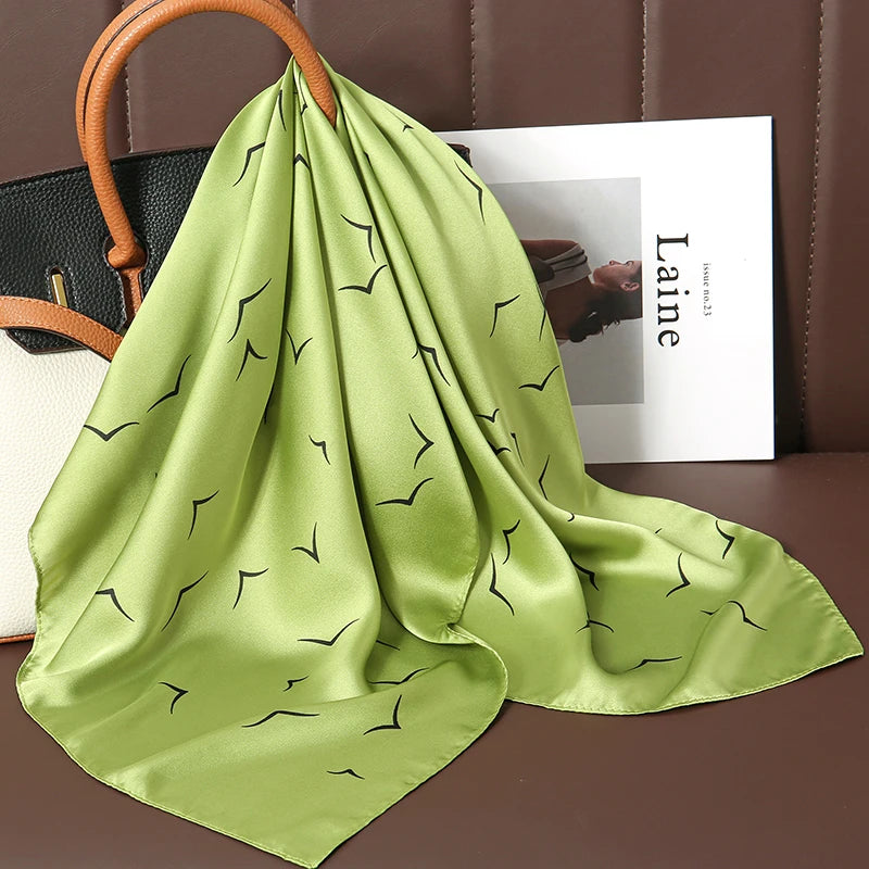 Image of Sophisticated Silk Satin Hijab Scarf, a polyester scarf with sun protection features, measuring 70cm x 70cm, and available in six colors. Perfect for spring and summer outings.