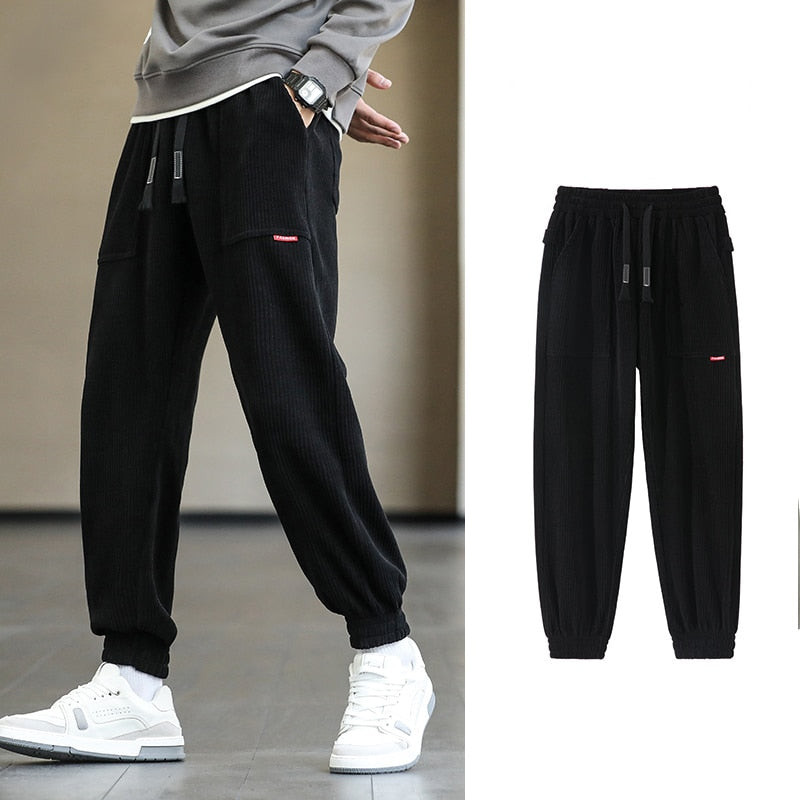 Men's Autumn Corduroy Sweatpants - Comfortable midweight design with drawstring closure. Available in sizes M to 8XL, in colors like Black, Blue, Grey, White, Yellow, and Brown. Perfect for autumn and winter.