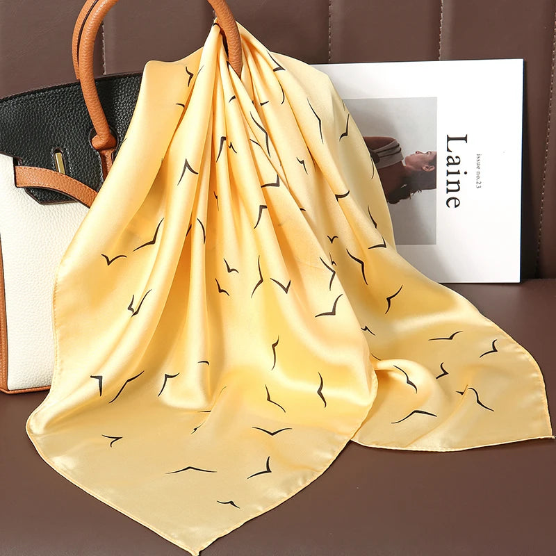 Image of Sophisticated Silk Satin Hijab Scarf, a polyester scarf with sun protection features, measuring 70cm x 70cm, and available in six colors. Perfect for spring and summer outings.