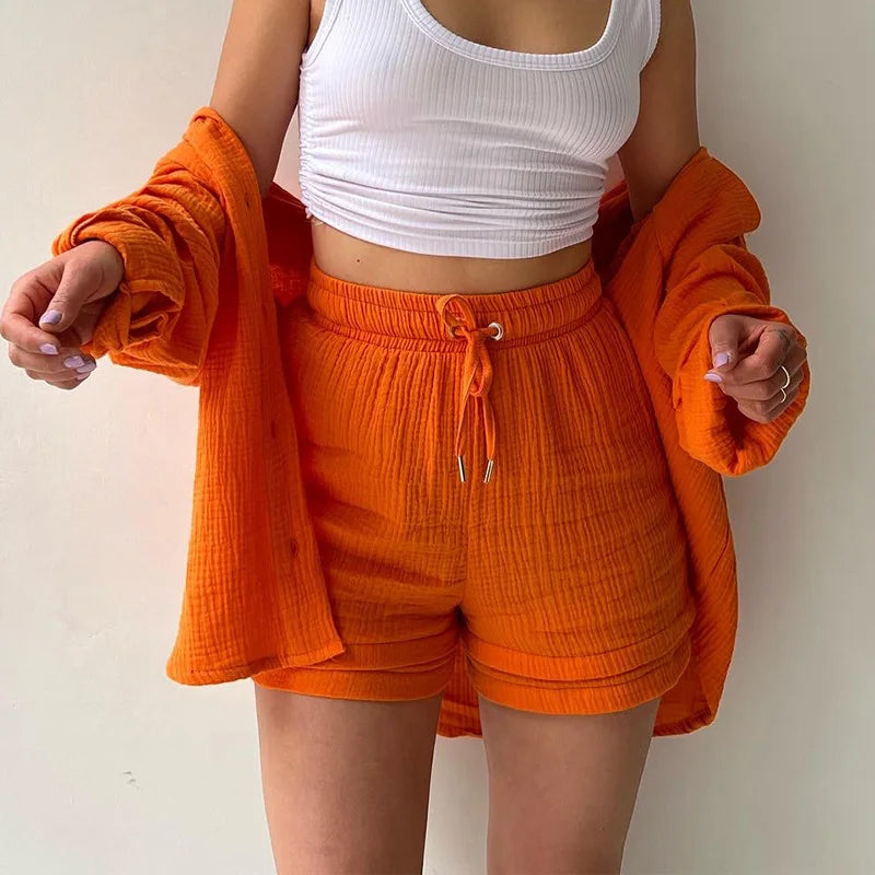 Two-Piece Buttoned Short Set for Women - Casual polo-neck top and knee-length pants set made from high-quality cotton fabric. Perfect for spring/summer 2024.