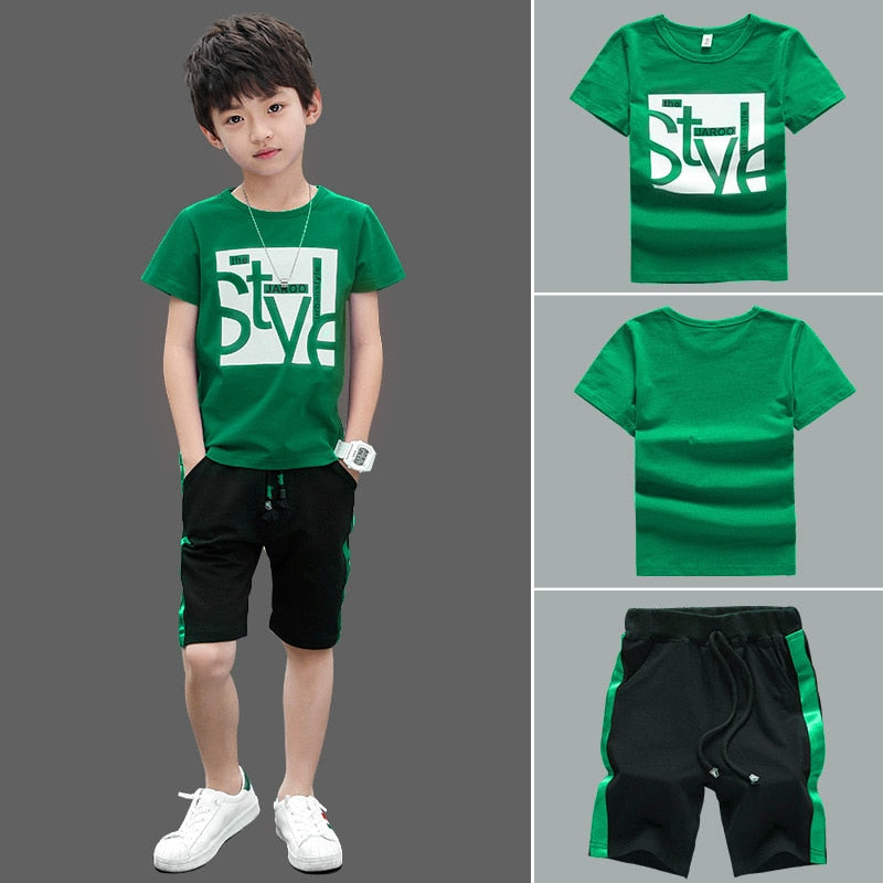 Image of a boy wearing a sports shirt and shorts in a fun design. Made from breathable cotton and polyester for comfort and durability during outdoor play and school sports activities.