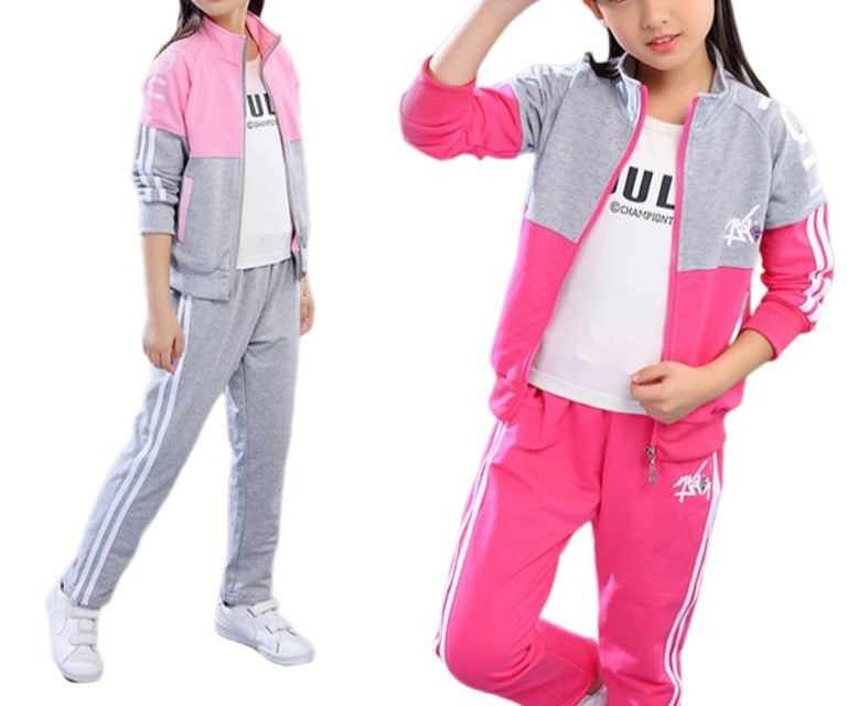 A young girl wearing a jacket and pants set. The jacket is made of a soft, comfortable material and the pants are made of a durable fabric. The set comes in a variety of colors and sizes to fit girls of all ages.