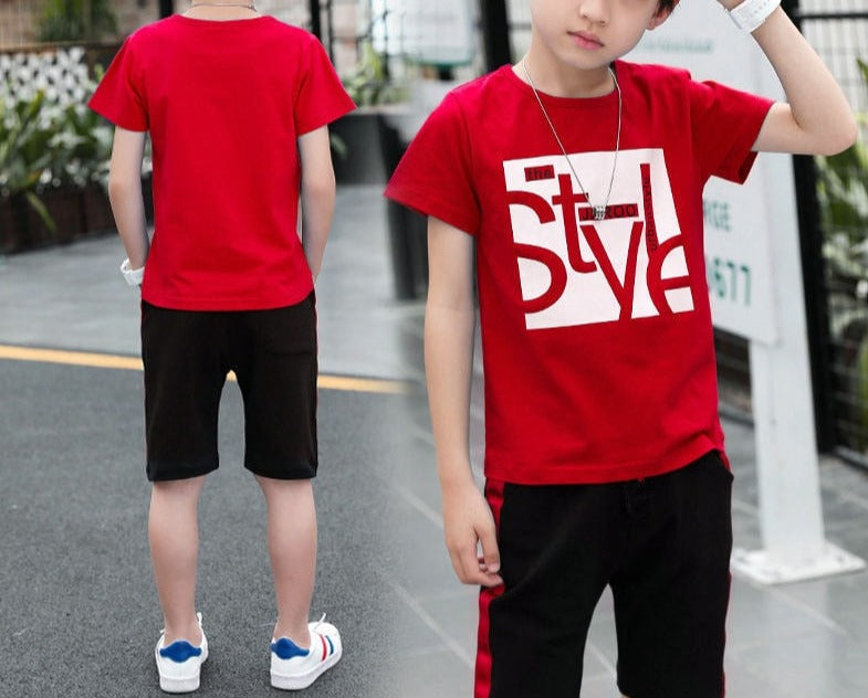 Image of a boy wearing a sports shirt and shorts in a fun design. Made from breathable cotton and polyester for comfort and durability during outdoor play and school sports activities.