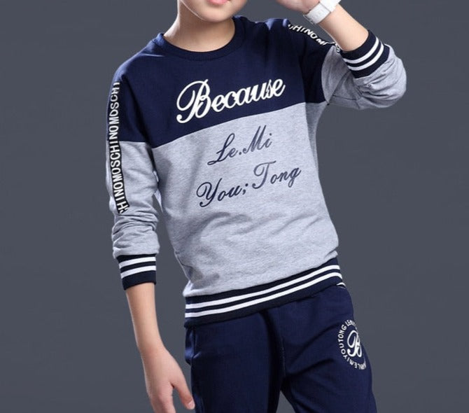 Boy wearing a casual clothing set made of 100% cotton and polyester, featuring a stylish combination of white and blue. Perfect for school, pair it with his favorite sneakers for a fashionable look.