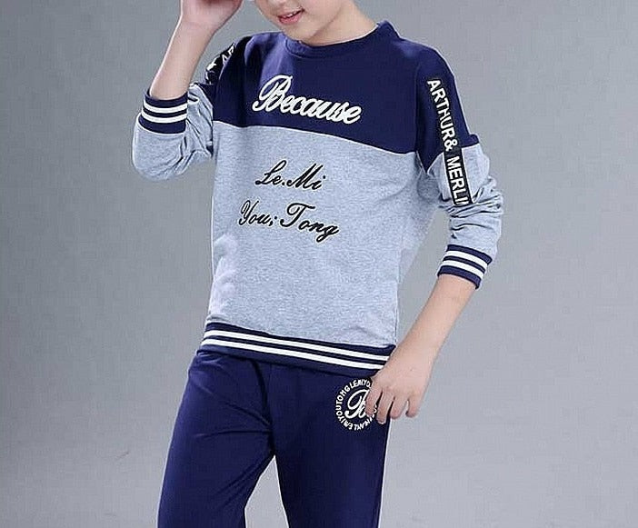 Boy wearing a casual clothing set made of 100% cotton and polyester, featuring a stylish combination of white and blue. Perfect for school, pair it with his favorite sneakers for a fashionable look.