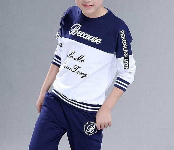 Boy wearing a casual clothing set made of 100% cotton and polyester, featuring a stylish combination of white and blue. Perfect for school, pair it with his favorite sneakers for a fashionable look.