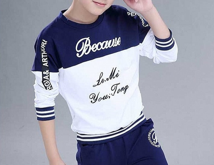 Boy wearing a casual clothing set made of 100% cotton and polyester, featuring a stylish combination of white and blue. Perfect for school, pair it with his favorite sneakers for a fashionable look.