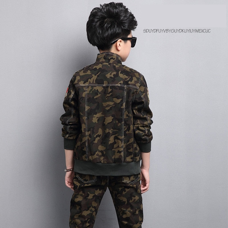 Boy wearing camouflage long-sleeve and pants set, made of cotton for comfort. Perfect for the classroom and playground. Please check our sizing chart for accurate measurements.