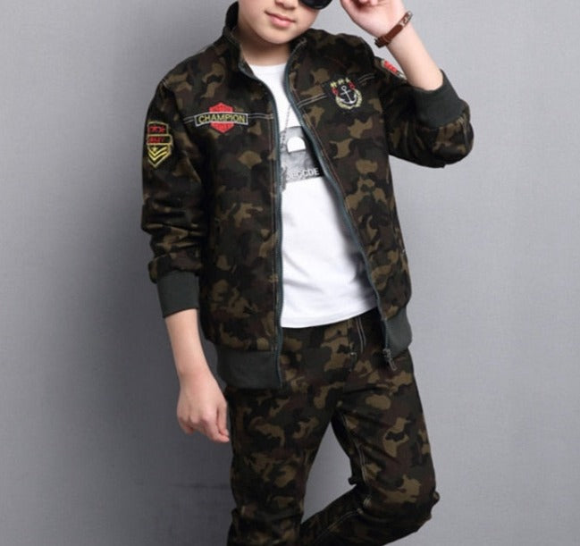 Boy wearing camouflage long-sleeve and pants set, made of cotton for comfort. Perfect for the classroom and playground. Please check our sizing chart for accurate measurements.