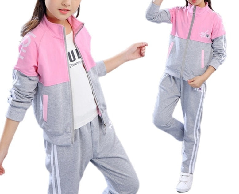 A young girl wearing a jacket and pants set. The jacket is made of a soft, comfortable material and the pants are made of a durable fabric. The set comes in a variety of colors and sizes to fit girls of all ages.