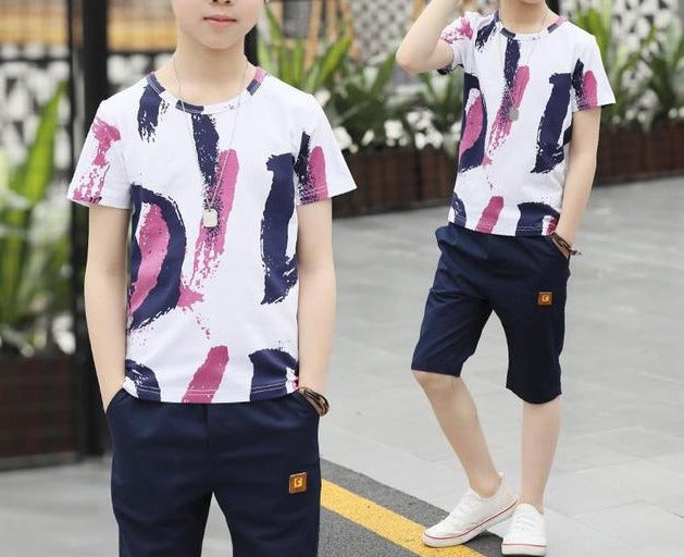 Image of a boy wearing a sports shirt and shorts in a fun design. Made from breathable cotton and polyester for comfort and durability during outdoor play and school sports activities.