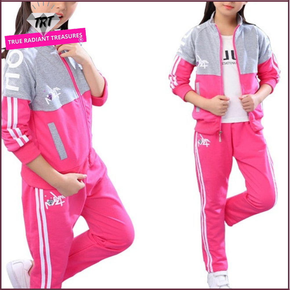 A young girl wearing a jacket and pants set. The jacket is made of a soft, comfortable material and the pants are made of a durable fabric. The set comes in a variety of colors and sizes to fit girls of all ages.