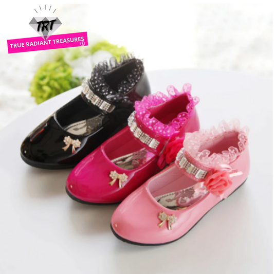 Stylish and shiny flat gladiator sandals for girls with ribbon loop embellishment and sparkling details.