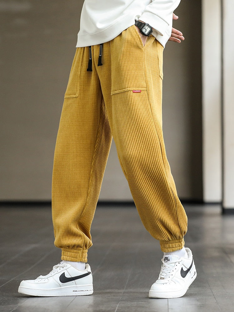 Men's Autumn Corduroy Sweatpants - Comfortable midweight design with drawstring closure. Available in sizes M to 8XL, in colors like Black, Blue, Grey, White, Yellow, and Brown. Perfect for autumn and winter.